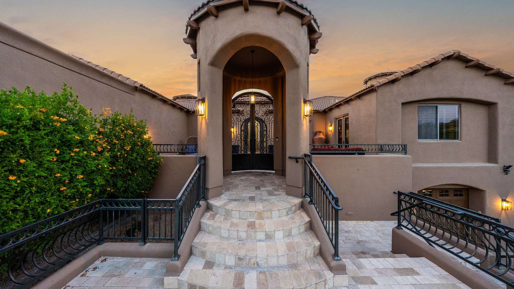 39 of 39. A curved staircase leads to the home s impressive arched front entrance, creating a grand sense of arrival. Flanked by blooming greenery and iron railings, the entryway sets the tone for a Scottsdale home that blends timeless design with sophisticated updates.