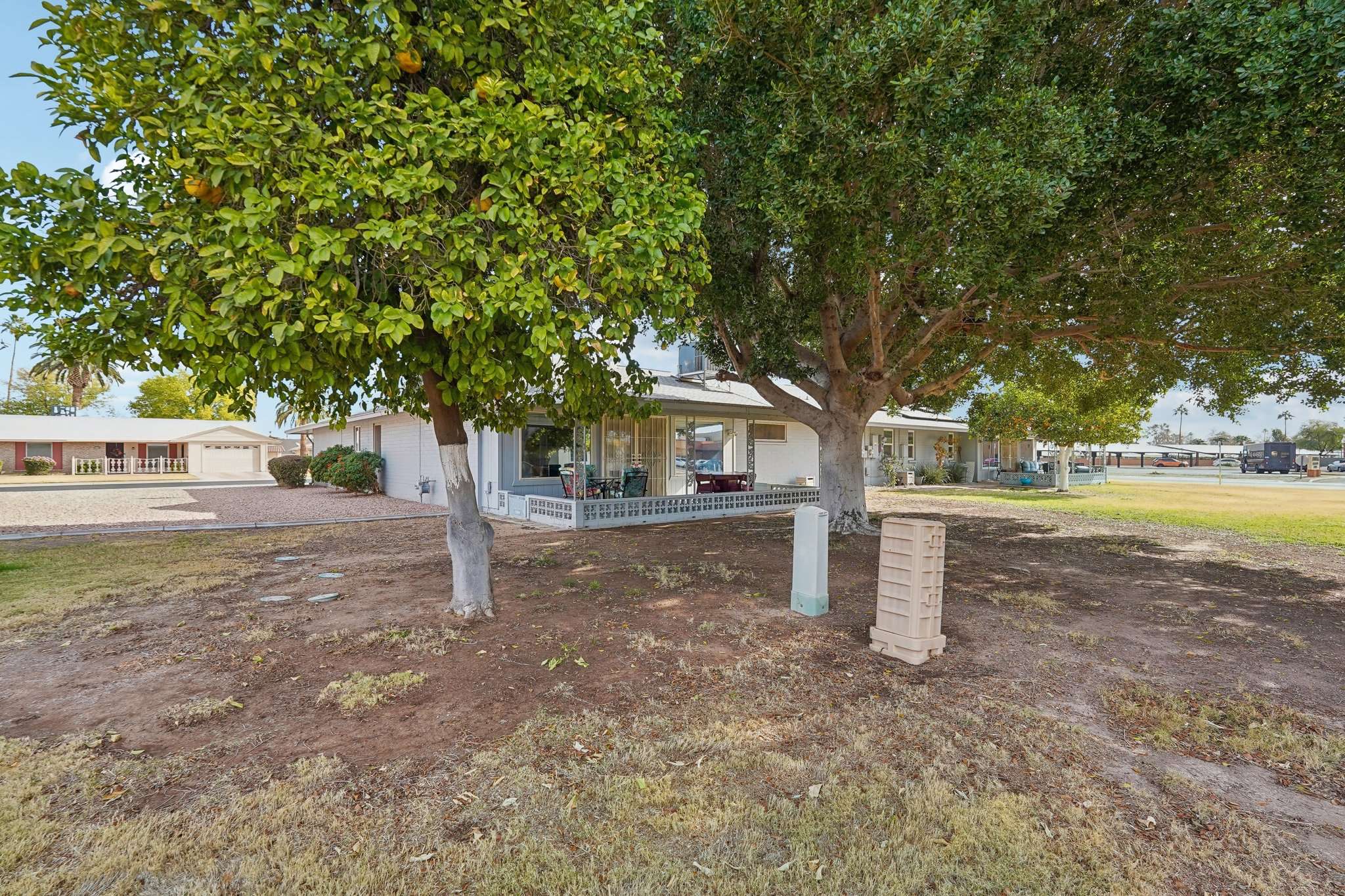 36 of 41. A spacious backyard with natural shade from mature trees, providing a tranquil setting for outdoor gatherings or simply enjoying Arizona s beautiful weather.