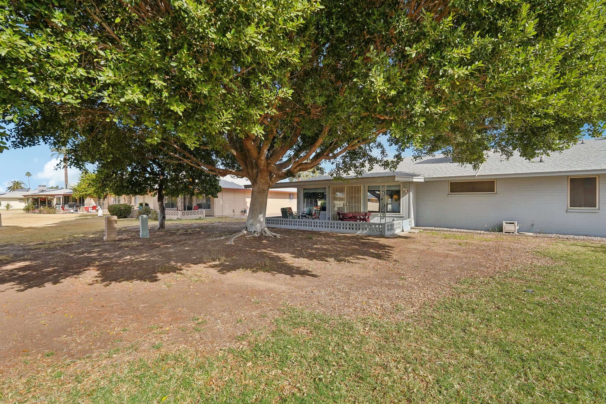 40 of 41. The expansive backyard features a massive shade tree, providing cool relief from the Arizona sun while creating a serene, park-like atmosphere.