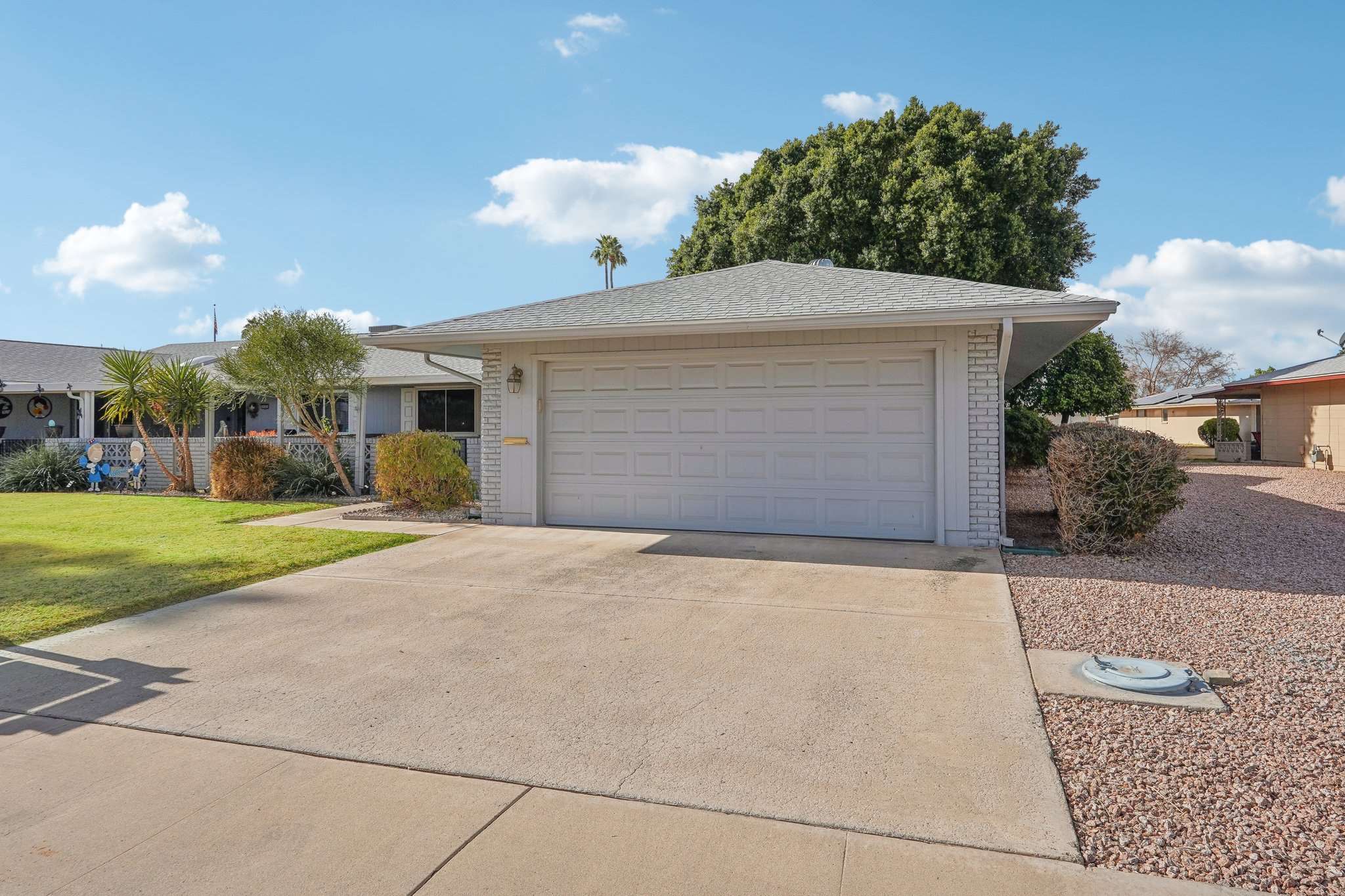 21 of 41. The spacious two-car garage and wide driveway provide ample parking for guests, vehicles, or a golf cart. A low-maintenance desert landscape completes this home s easy-living appeal.