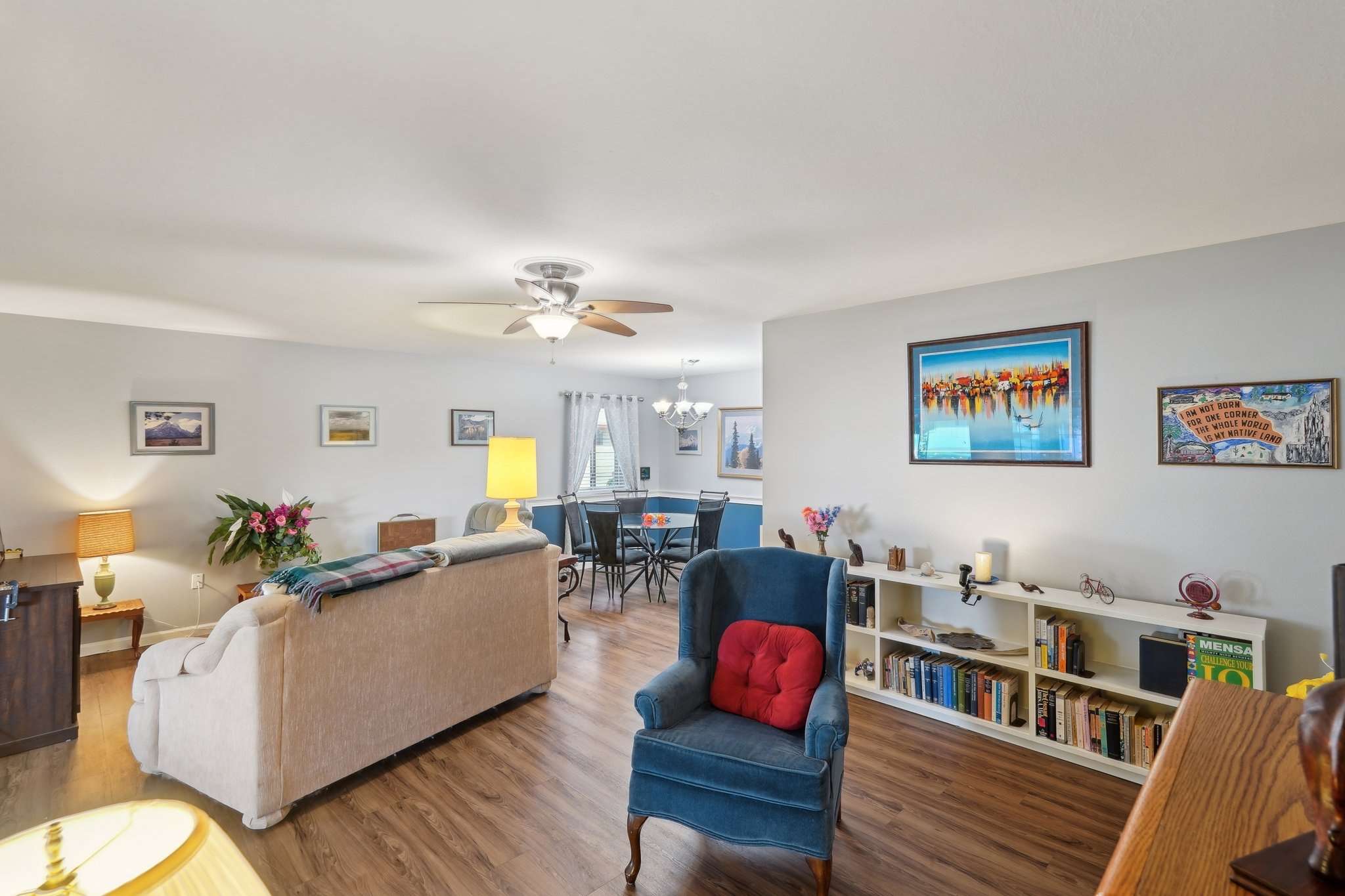 4 of 41. This bright and open living space features laminate wood flooring, built-in shelving, and neutral tones. A perfect gathering spot for relaxing or entertaining in this move-in-ready Sun City home.