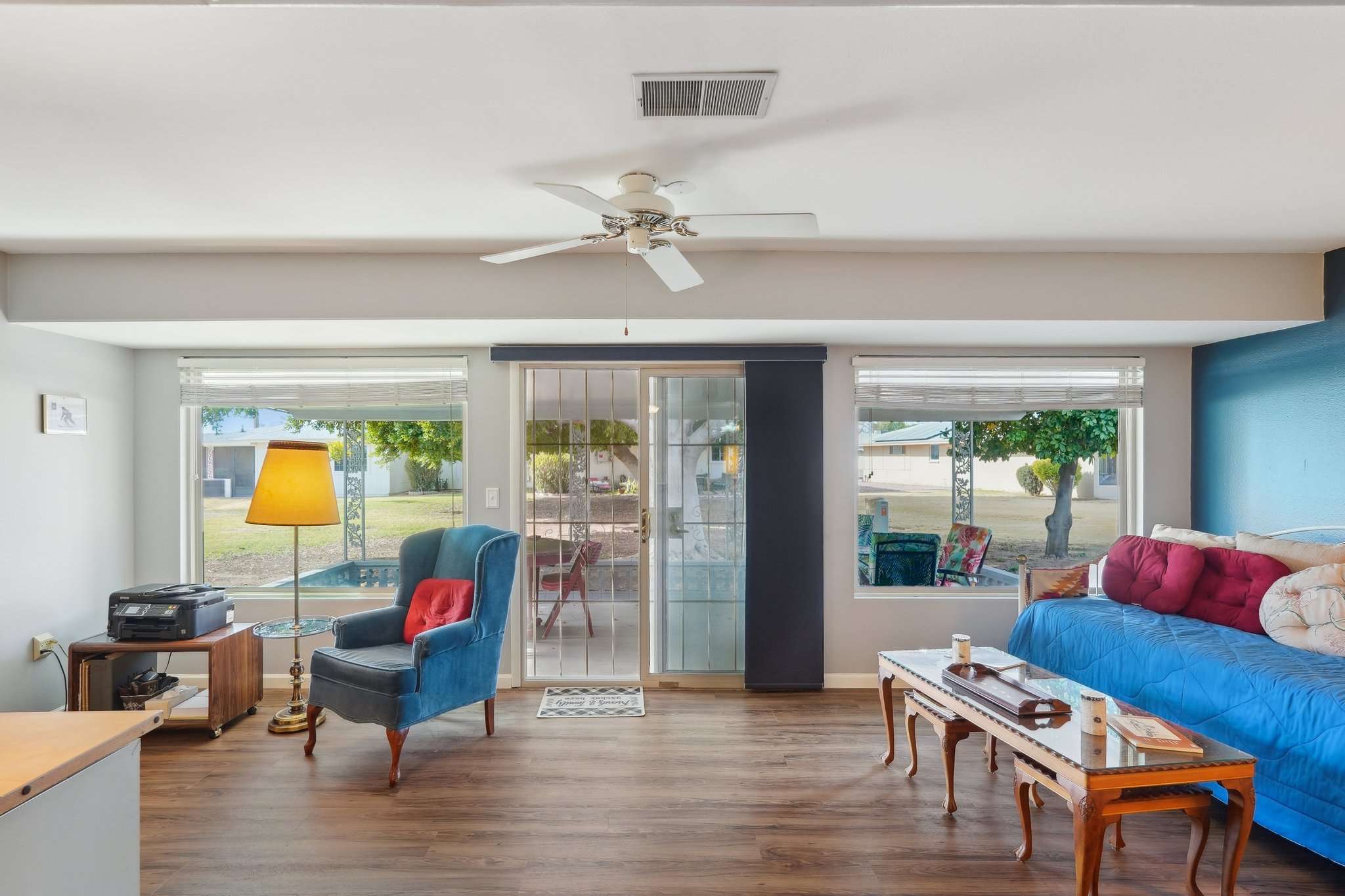 7 of 41. Enjoy relaxing backyard views from the extended Arizona room, featuring large windows, sliding patio access, and bright natural light. A perfect spot for morning coffee or an extra lounge area!