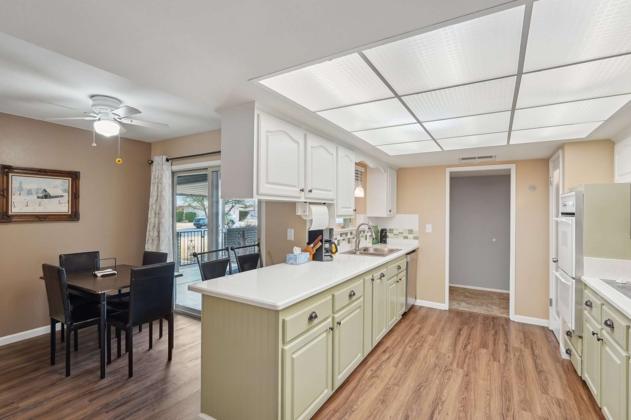 11 of 41. This renovated kitchen boasts elegant cabinetry, quartz countertops, and an upgraded backsplash. The spacious layout is perfect for cooking, hosting, and everyday living.