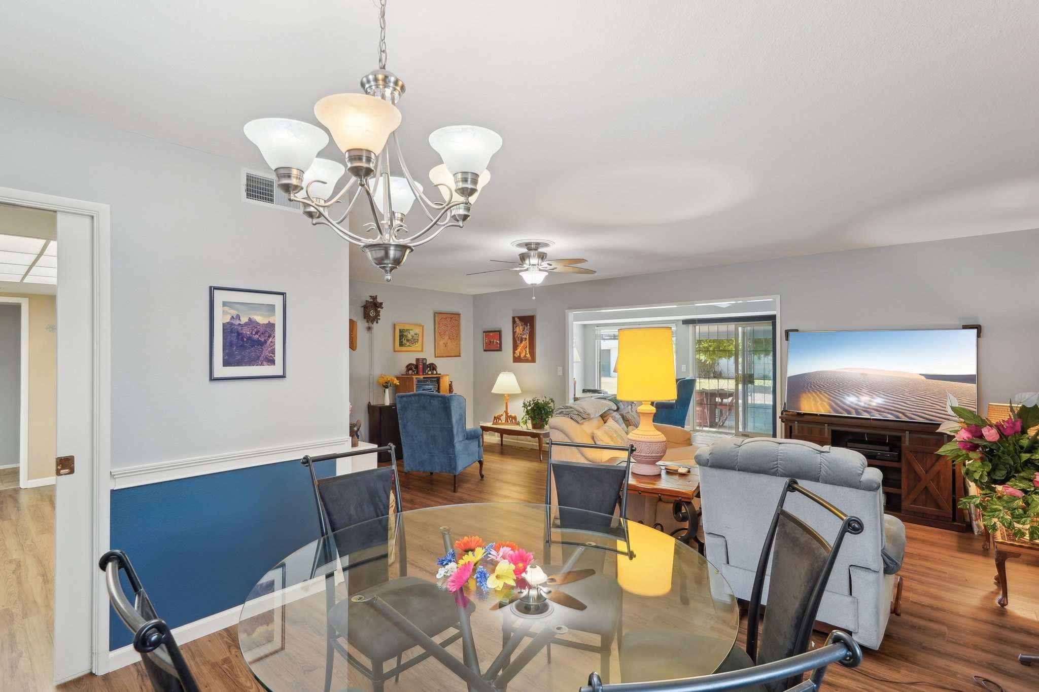 12 of 41. The formal dining space is framed by wainscoting details, soft neutral tones, and a stylish chandelier a perfect setting for both casual meals and dinner parties.