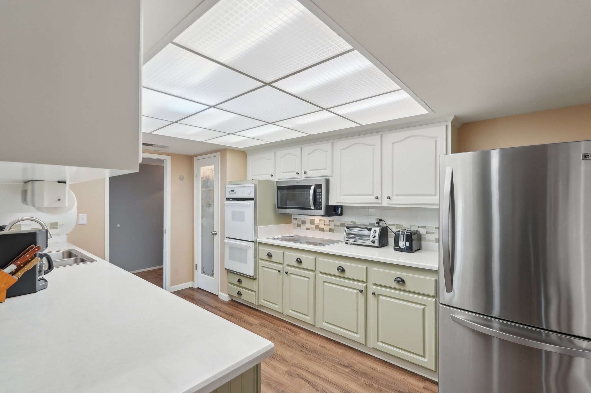 14 of 41. This well-appointed kitchen features sleek countertops, dual ovens, and stylish cabinetry. The efficient layout makes meal prep a breeze in this move-in-ready home.