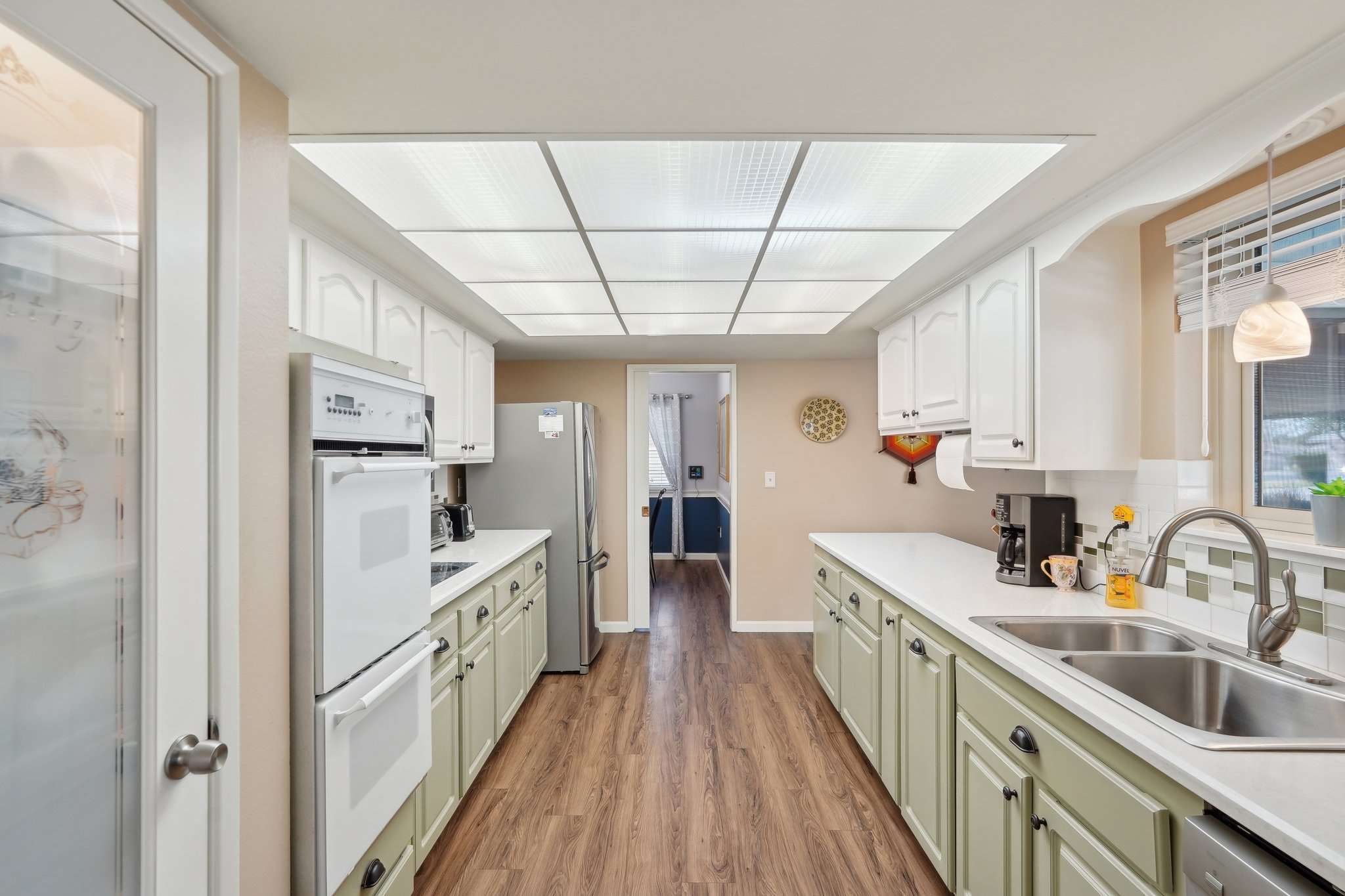 15 of 41. The galley-style kitchen provides ample counter space, updated appliances, and custom cabinetry. A well-lit workspace makes it ideal for home chefs and entertaining.