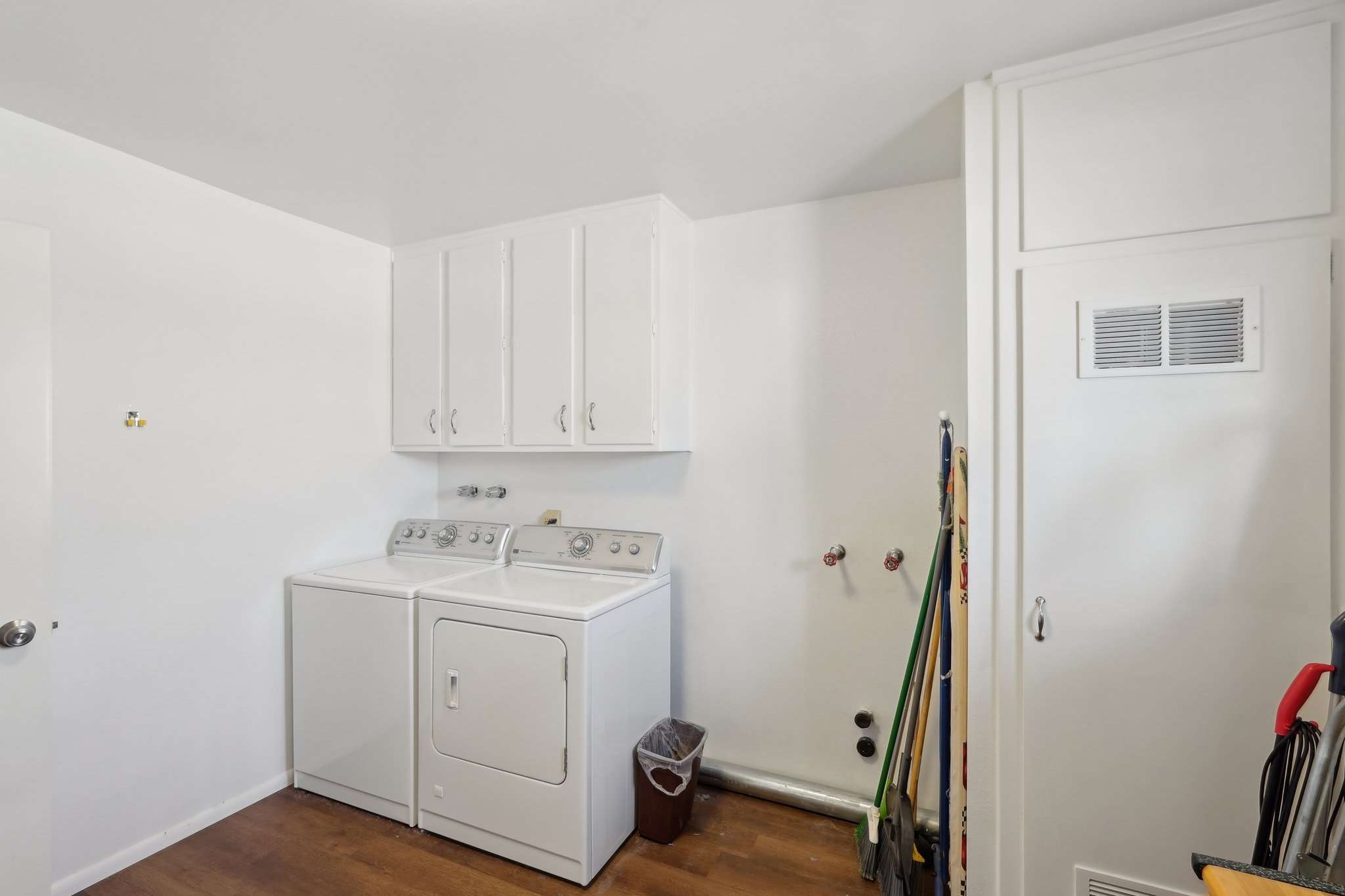 16 of 41. The spacious laundry room features a washer & dryer, storage cabinets, and additional space for organization, making household chores more convenient and efficient.