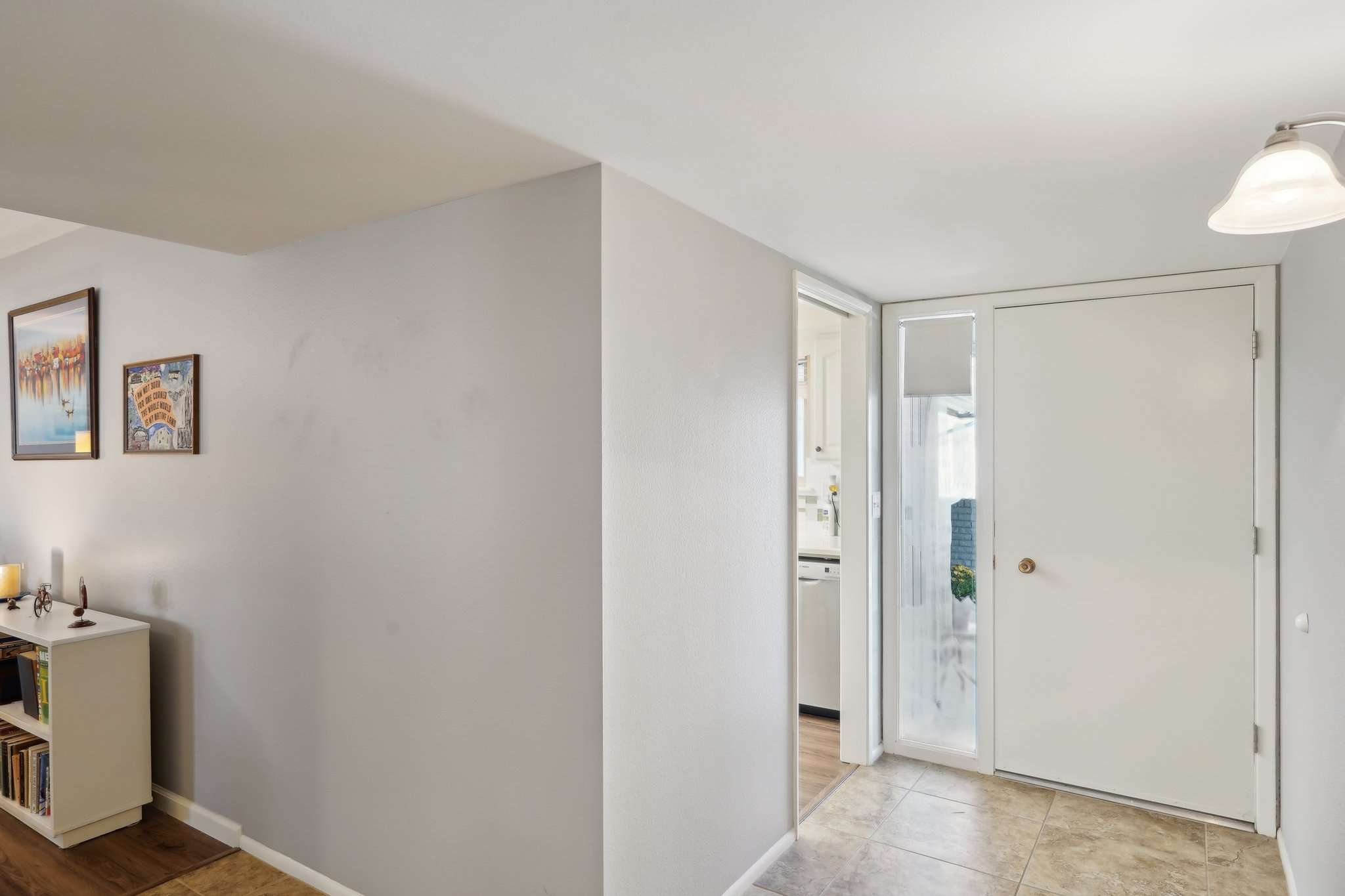 18 of 41. Step inside this bright and inviting entryway featuring neutral tones, tile flooring, and easy access to the kitchen and living area. A perfect first impression for your guests.