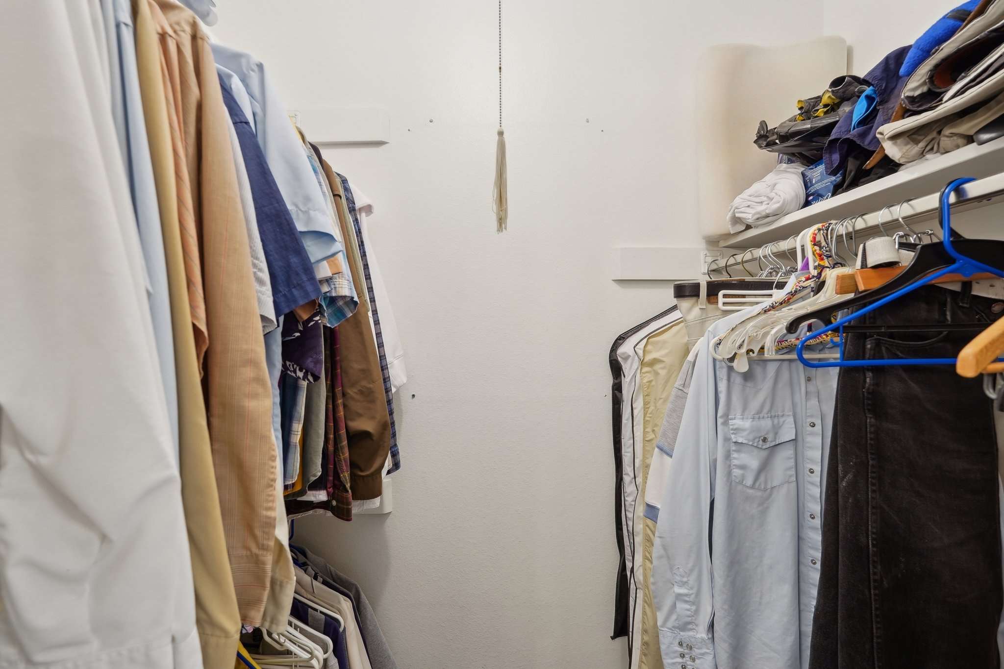 27 of 41. This large walk-in closet provides plenty of shelving, hanging space, and storage to keep your wardrobe organized and accessible.