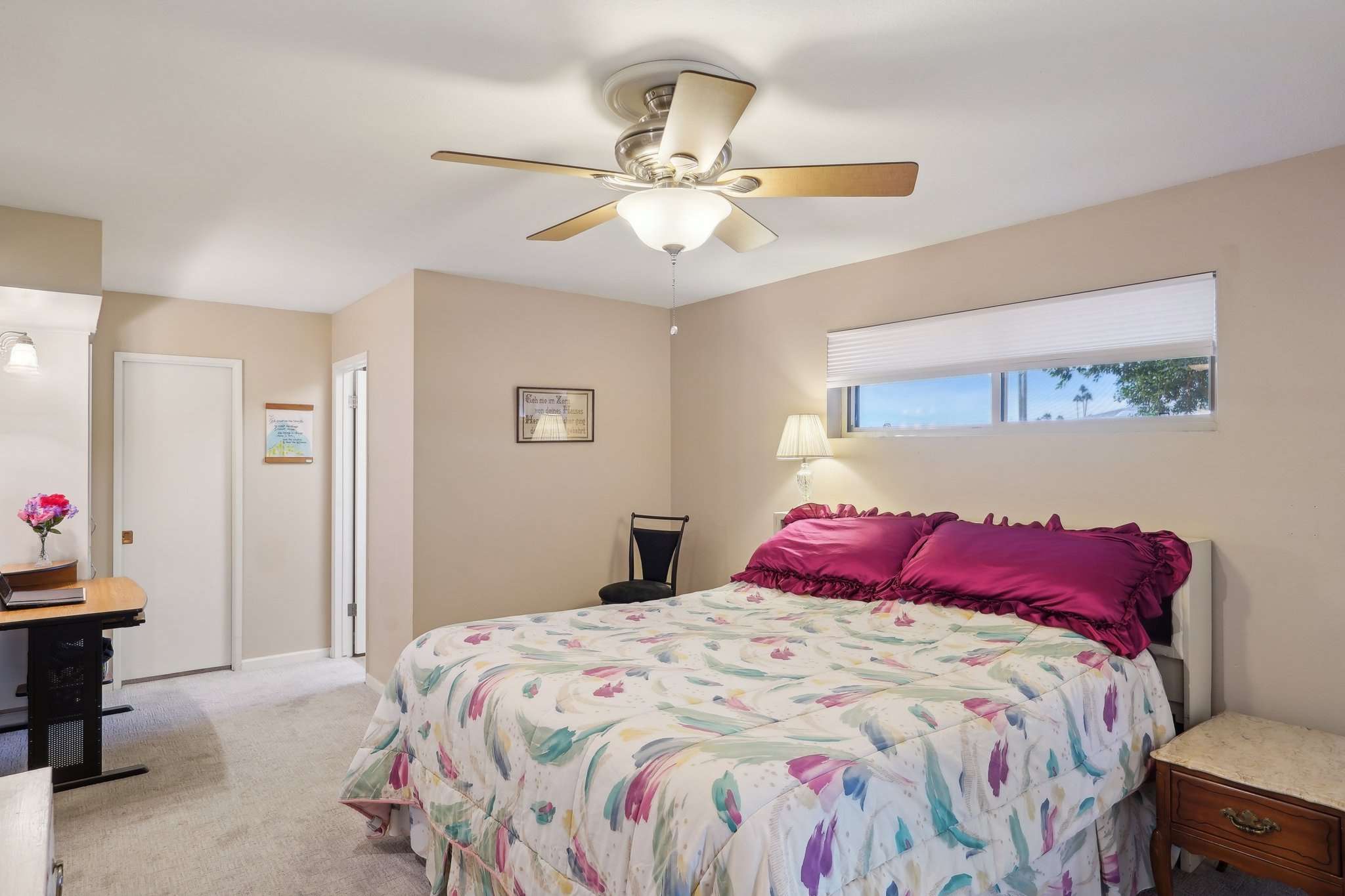 29 of 41. This cozy and inviting bedroom features a ceiling fan, neutral tones, and a private en-suite bath. A perfect space to unwind.