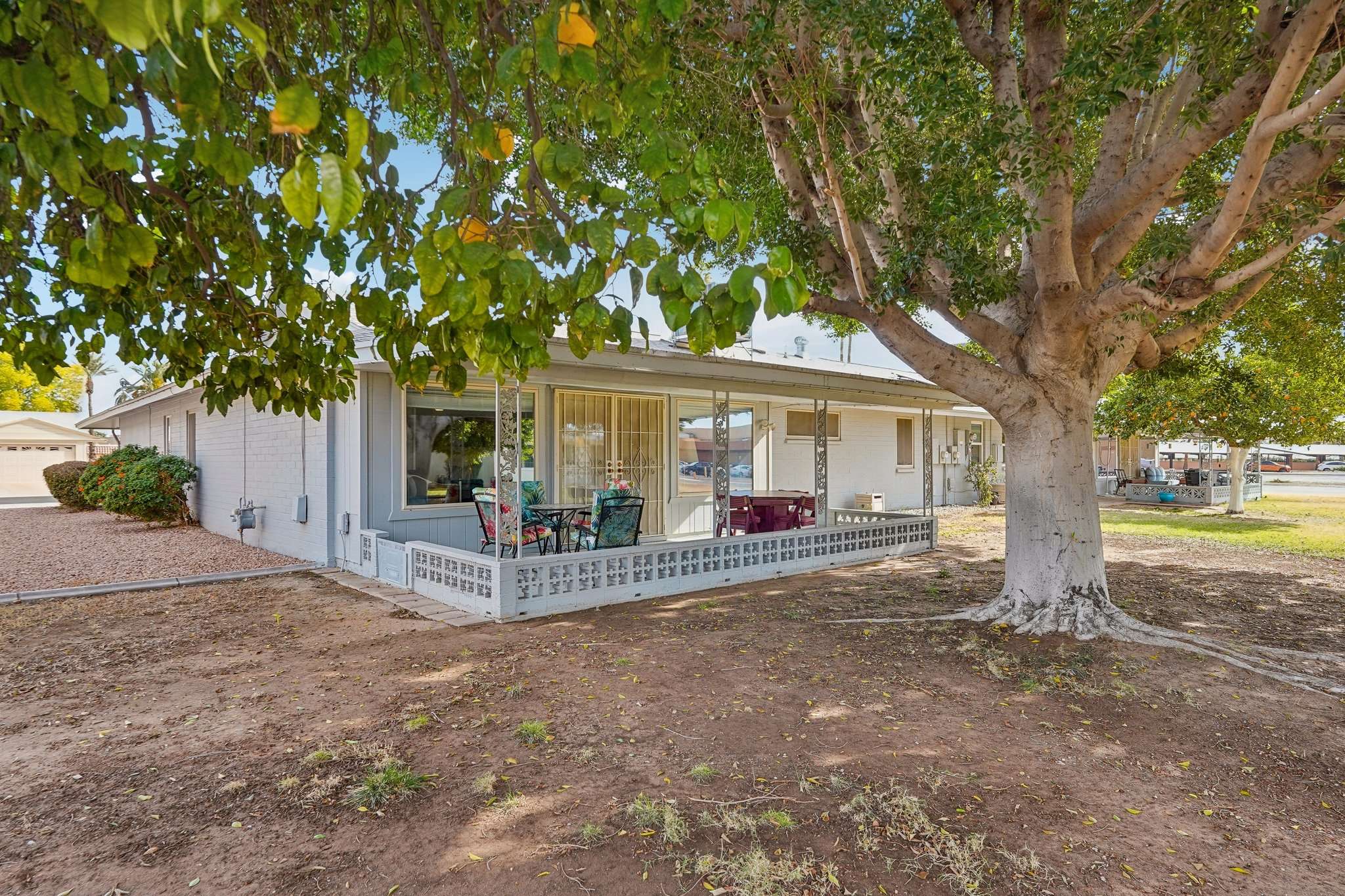 38 of 41. This private backyard features a mature tree for shade, a covered patio, and open space, making it a perfect place for outdoor relaxation or small gatherings.