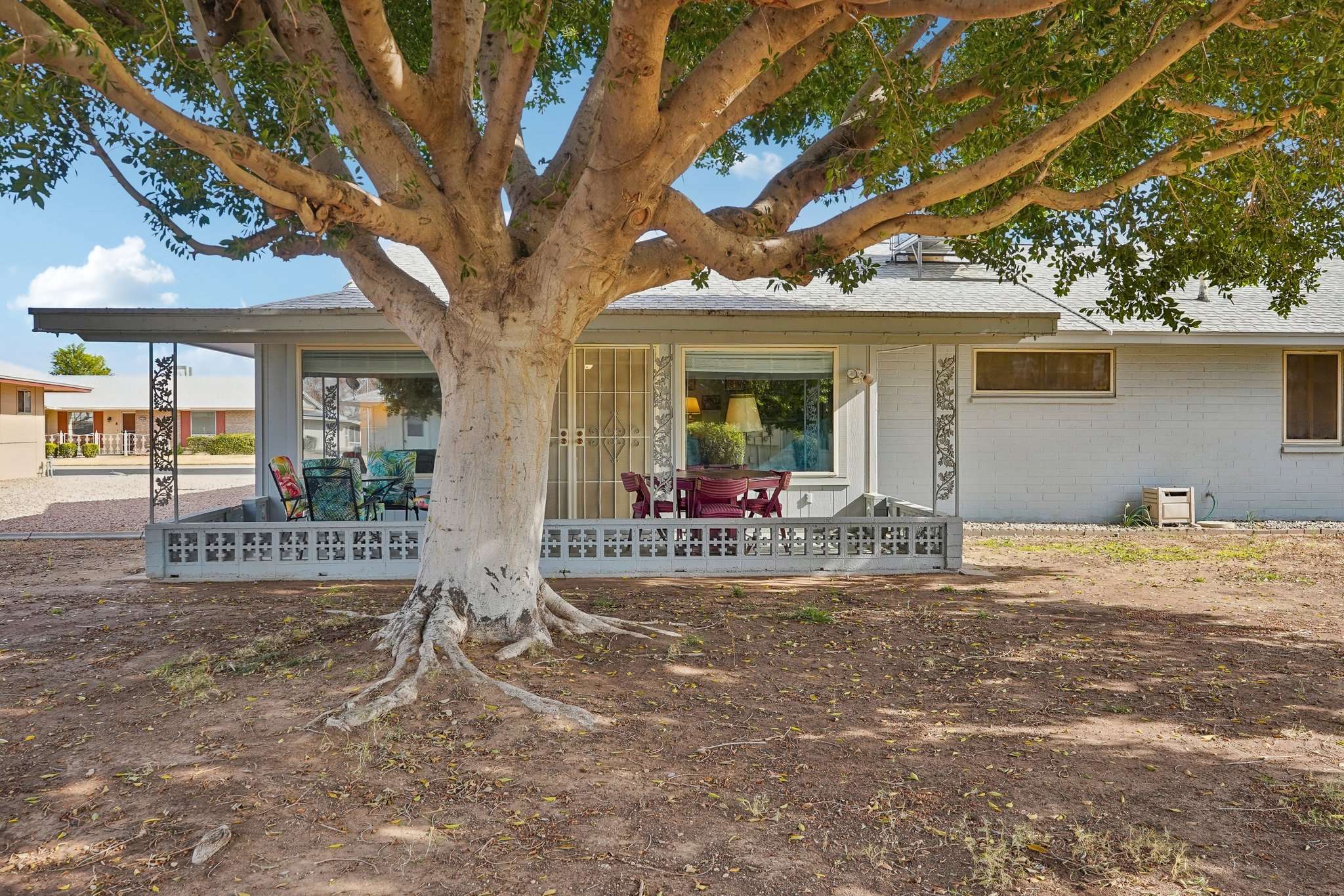 39 of 41. This backyard setting includes a covered patio, mature trees, and ample space, offering a relaxing outdoor retreat with beautiful views of the community.