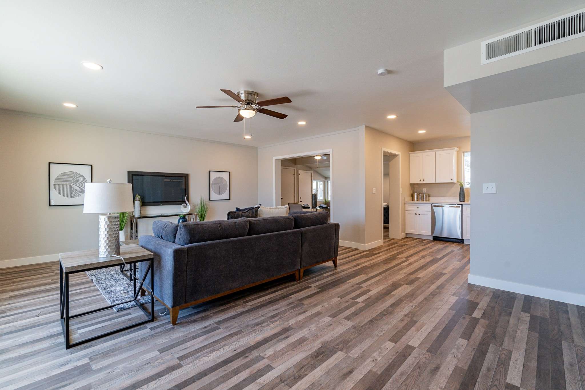 10 of 35. This modern, open-concept living space features neutral tones, updated flooring, and natural light perfect for hosting guests or enjoying quiet moments in a comfortable, move-in-ready home.