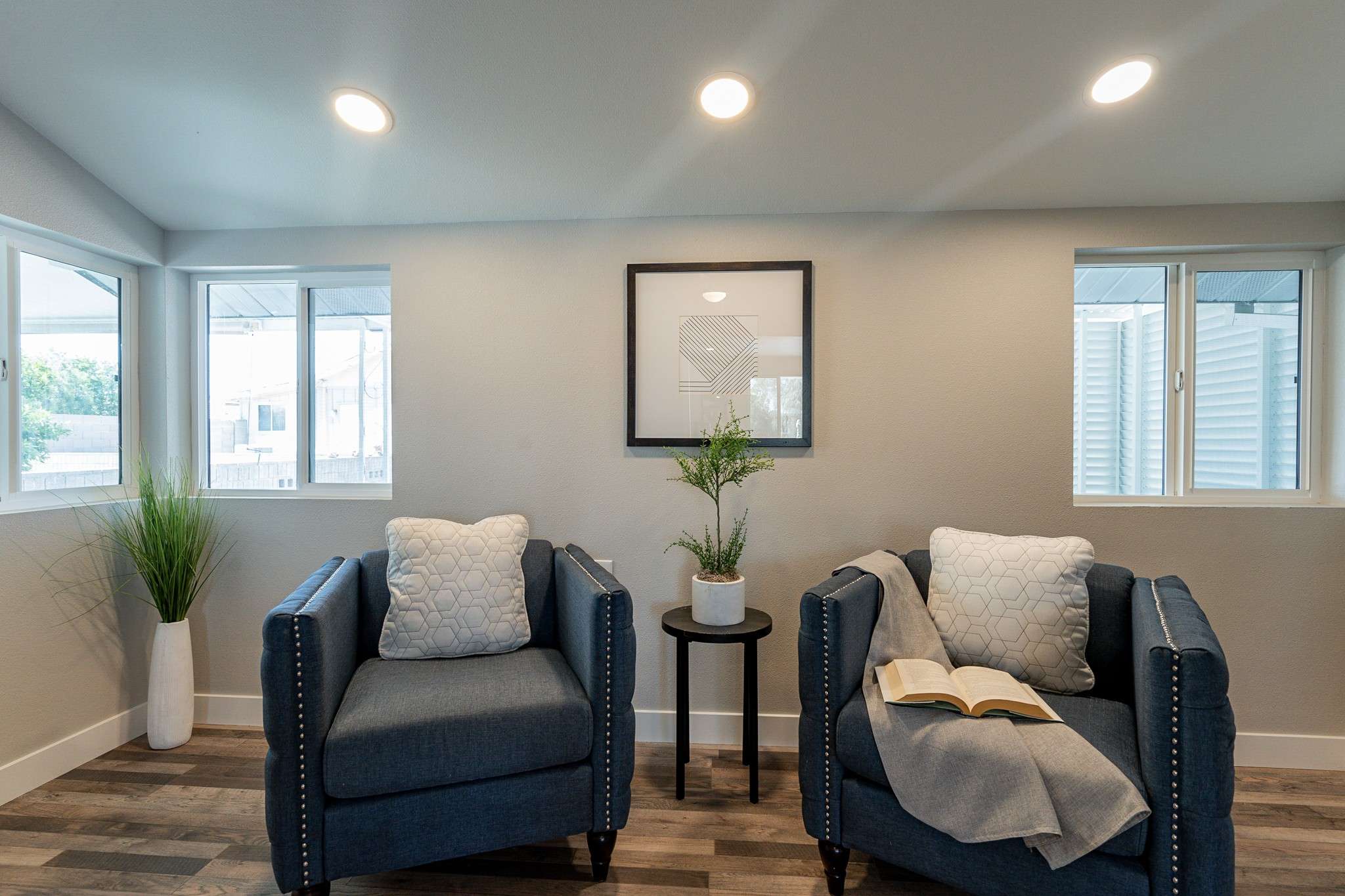 19 of 35. This inviting reading nook offers large windows, modern lighting, and a peaceful ambiance. A perfect space for enjoying a cup of coffee or relaxing with a book.