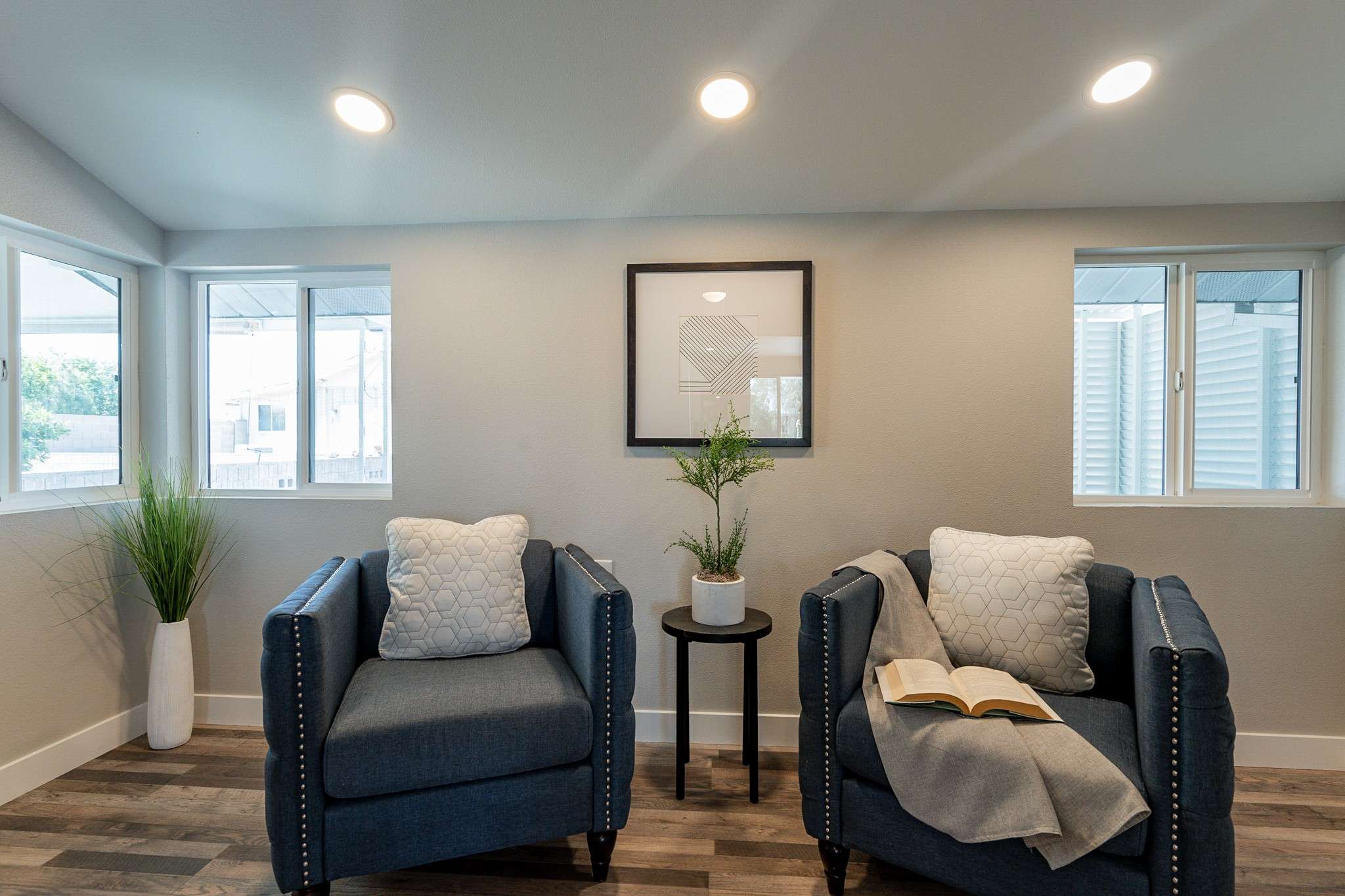 20 of 35. A bright and cozy sitting area with dual-pane windows, stylish accents, and recessed lighting. An ideal space to enjoy natural light and relaxation.
