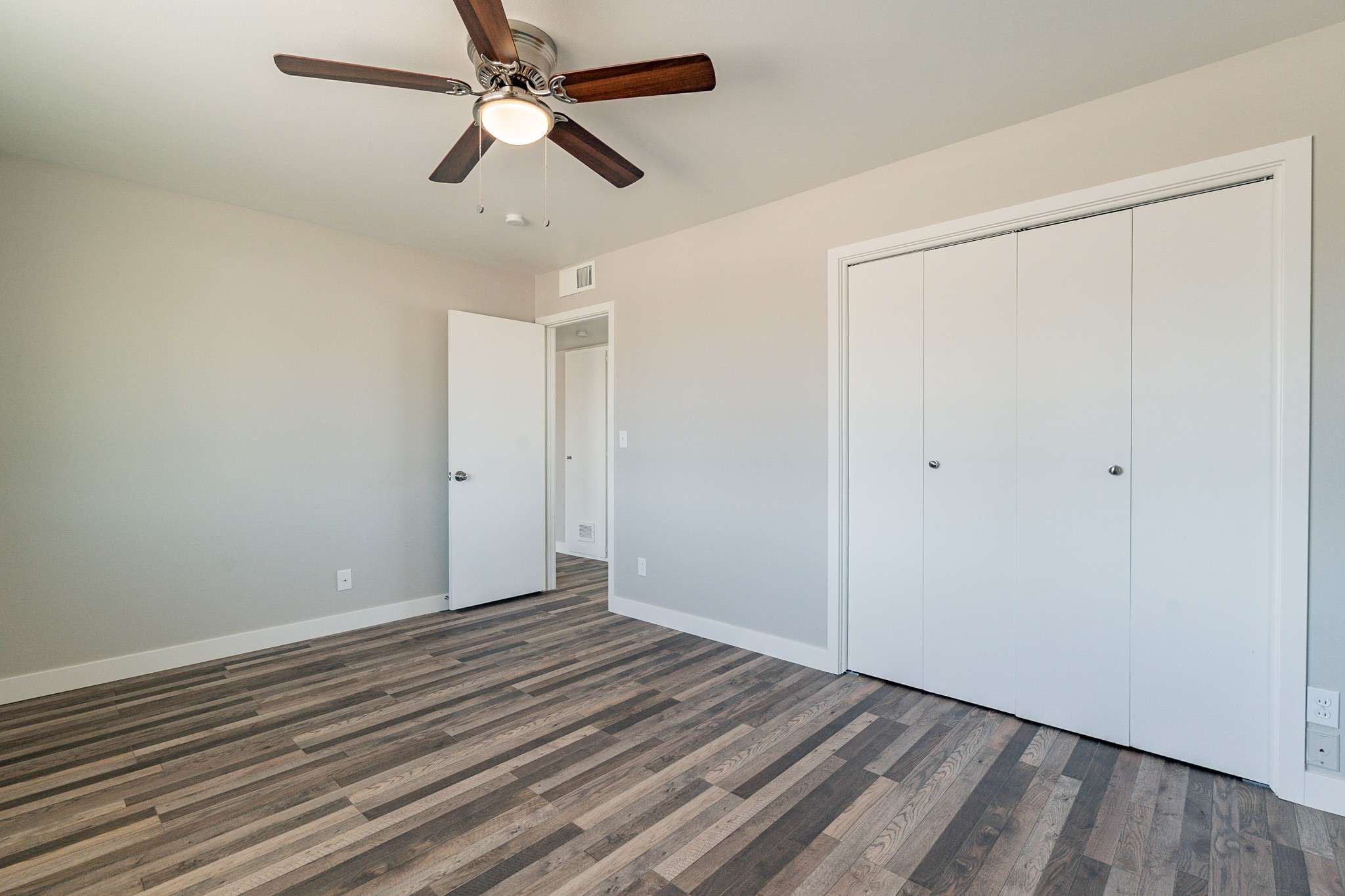 22 of 35. A well-sized bedroom featuring a large closet, neutral tones, and sleek flooring. This space offers versatility and is ready for personalization.