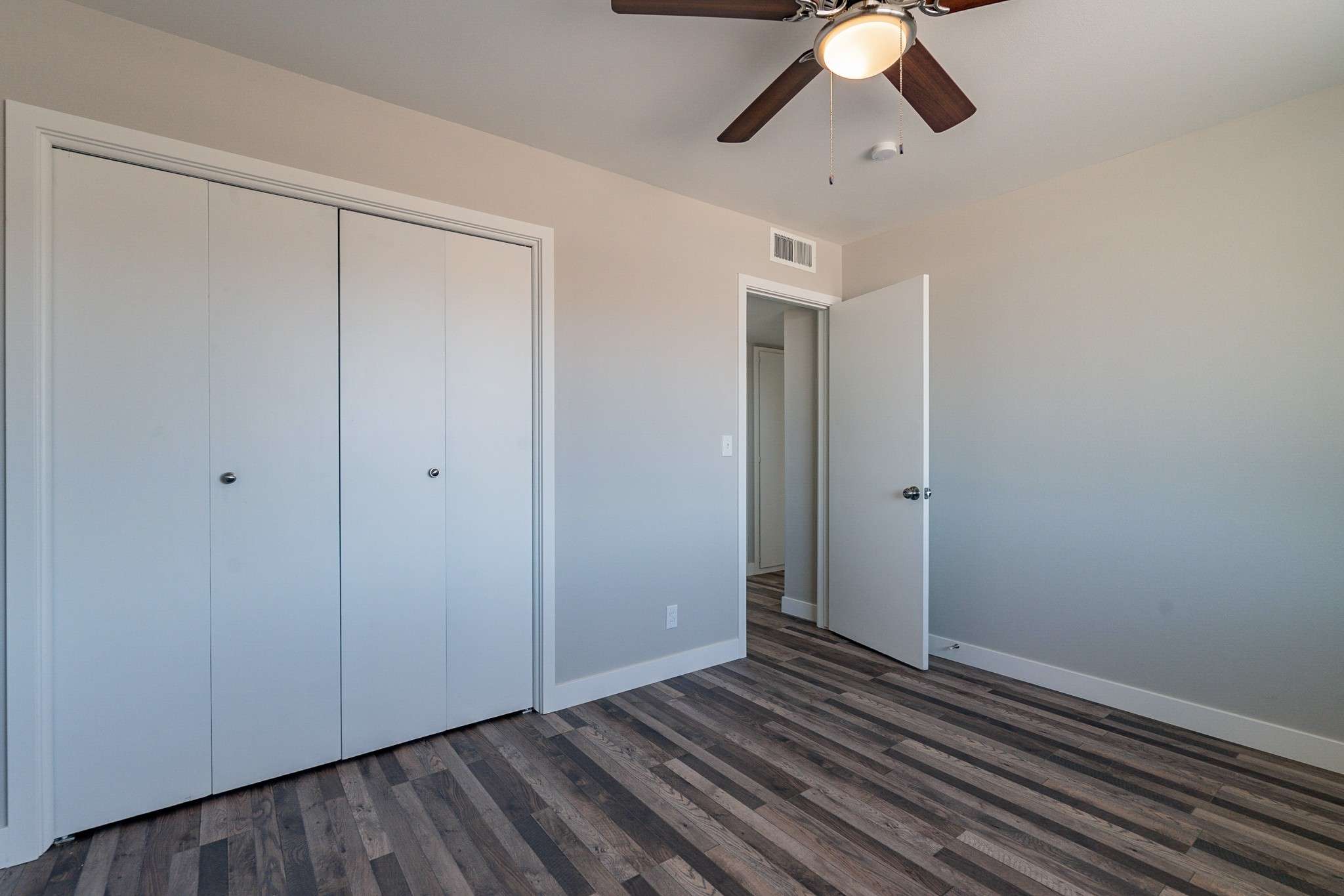 24 of 35. This modern bedroom boasts fresh flooring, a neutral color scheme, and a built-in closet for easy storage. Move-in ready and waiting for your personal touch.