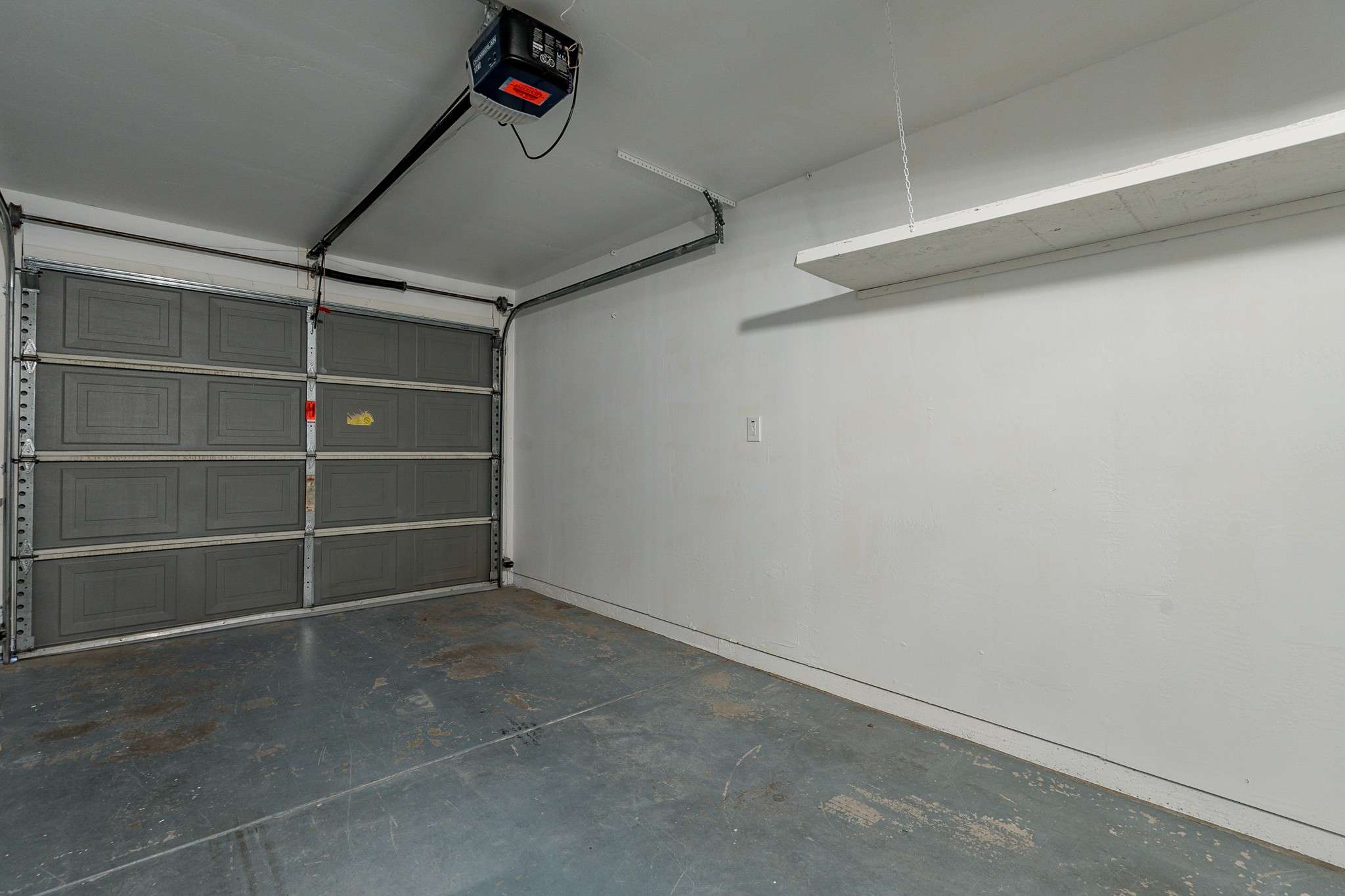 27 of 35. A spacious two-car garage featuring a durable door, ample storage options, and convenient access to the home. Perfect for vehicles and additional storage.