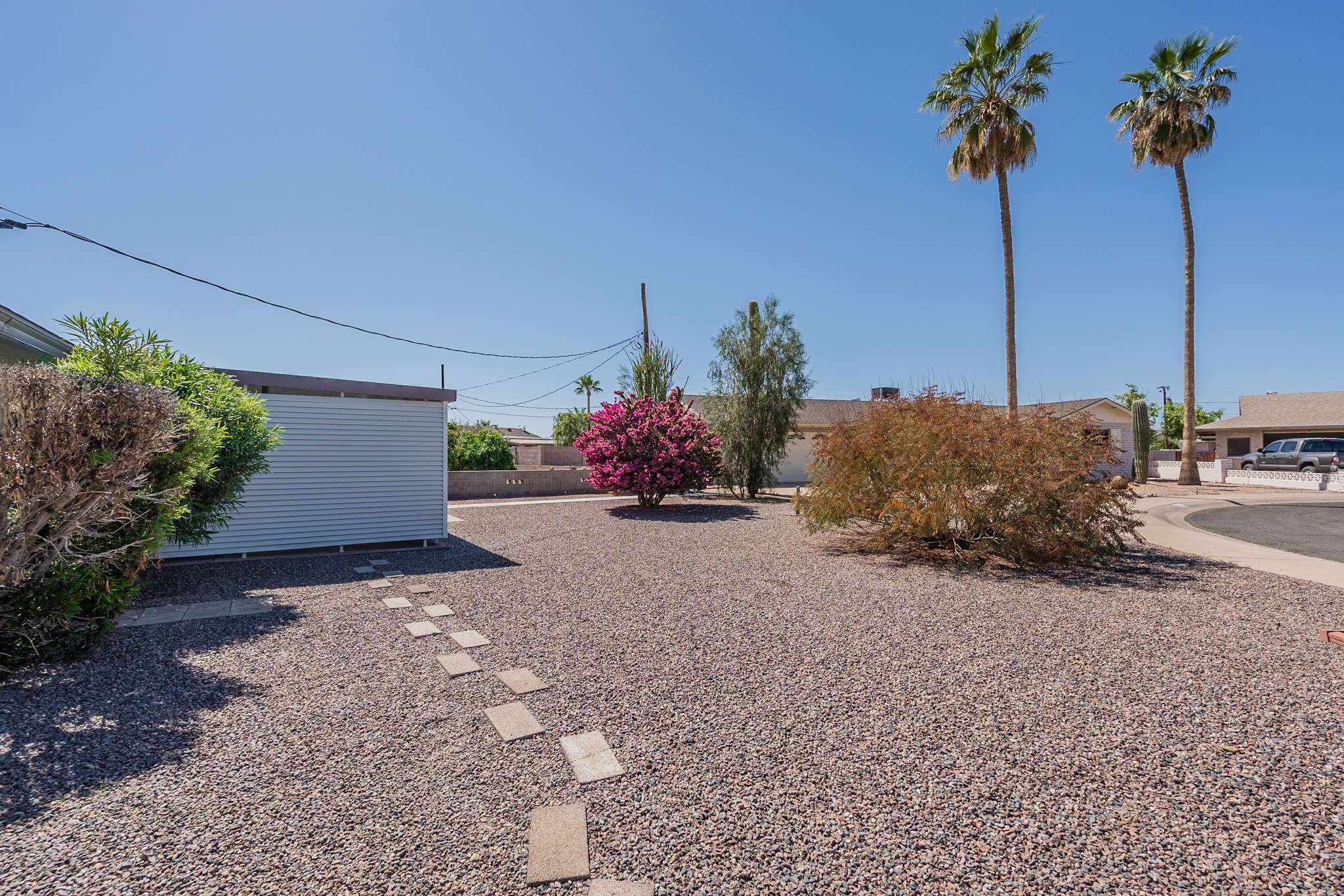 33 of 35. This generously sized corner lot boasts a well-maintained, drought-friendly landscape with stunning desert plants. The open layout offers ample space for expansion, gardening, or simply enjoying the peaceful outdoor setting.