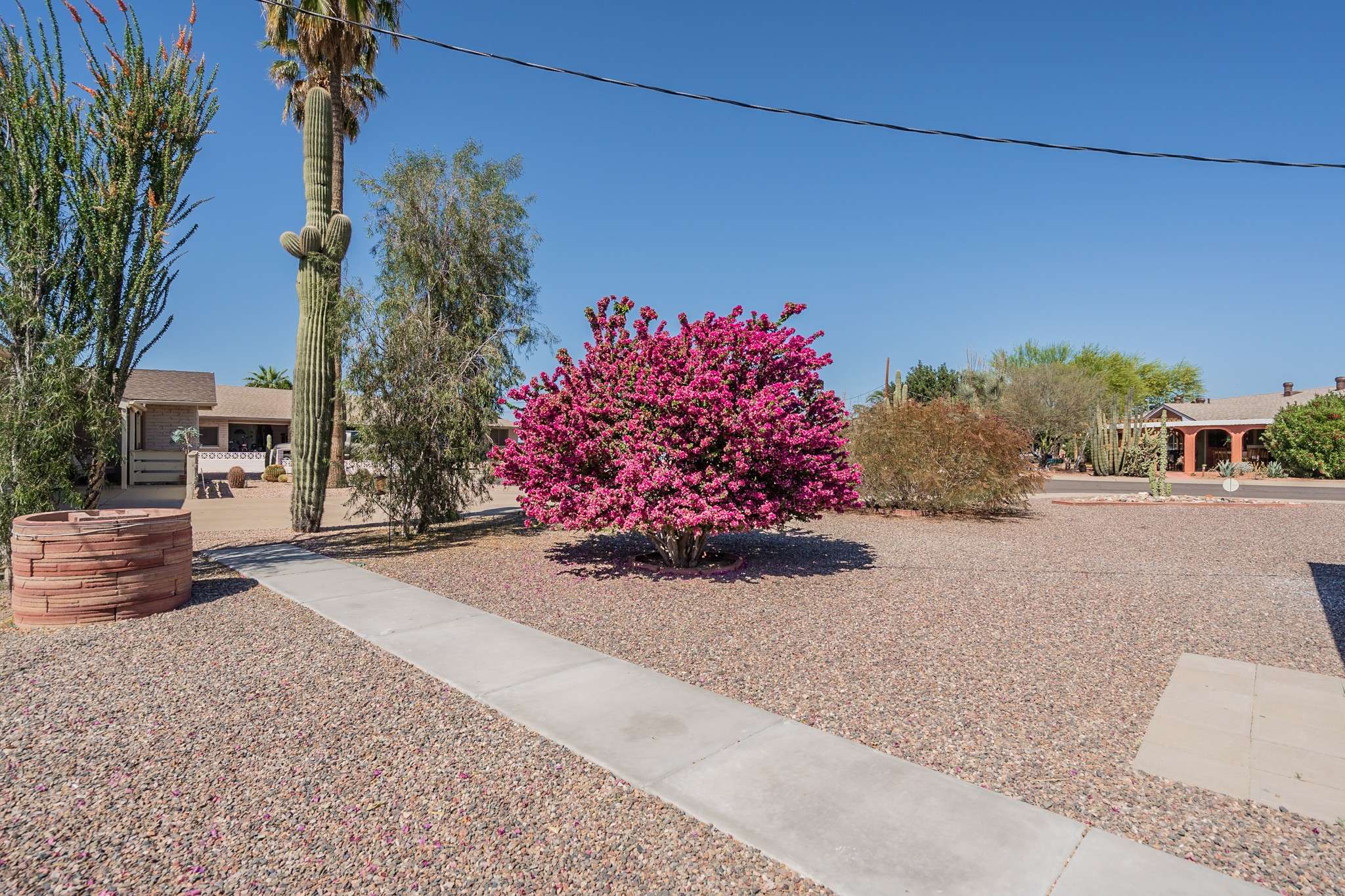 35 of 35. A welcoming concrete path winds through this thoughtfully landscaped yard, guiding you past native desert plants. This inviting outdoor space enhances the home s curb appeal and provides a warm, welcoming entry.