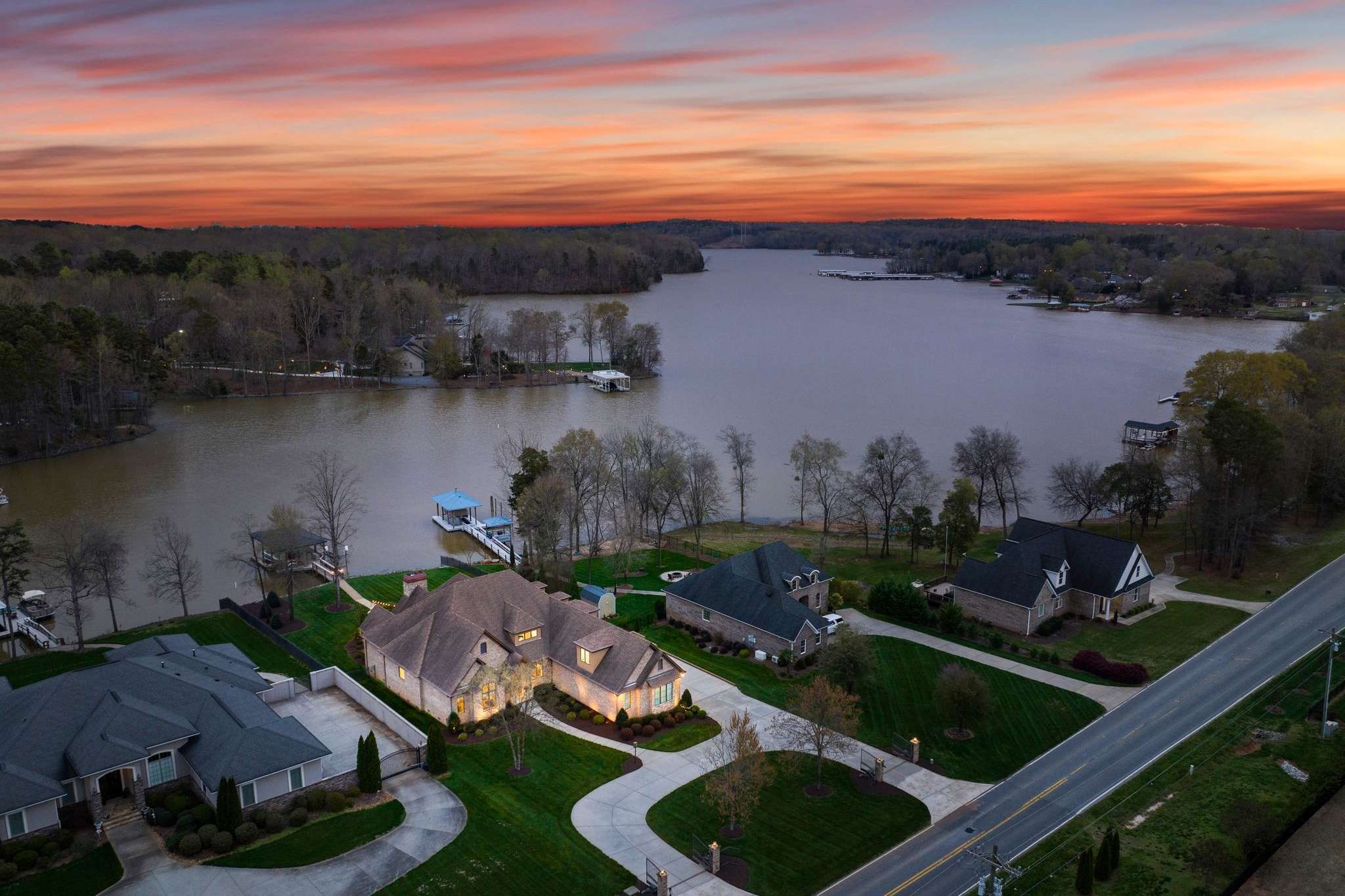 7 of 79. Exterior twilight drone photo of 846 Armstrong Dr showing prime waterfront location on Lake Wylie