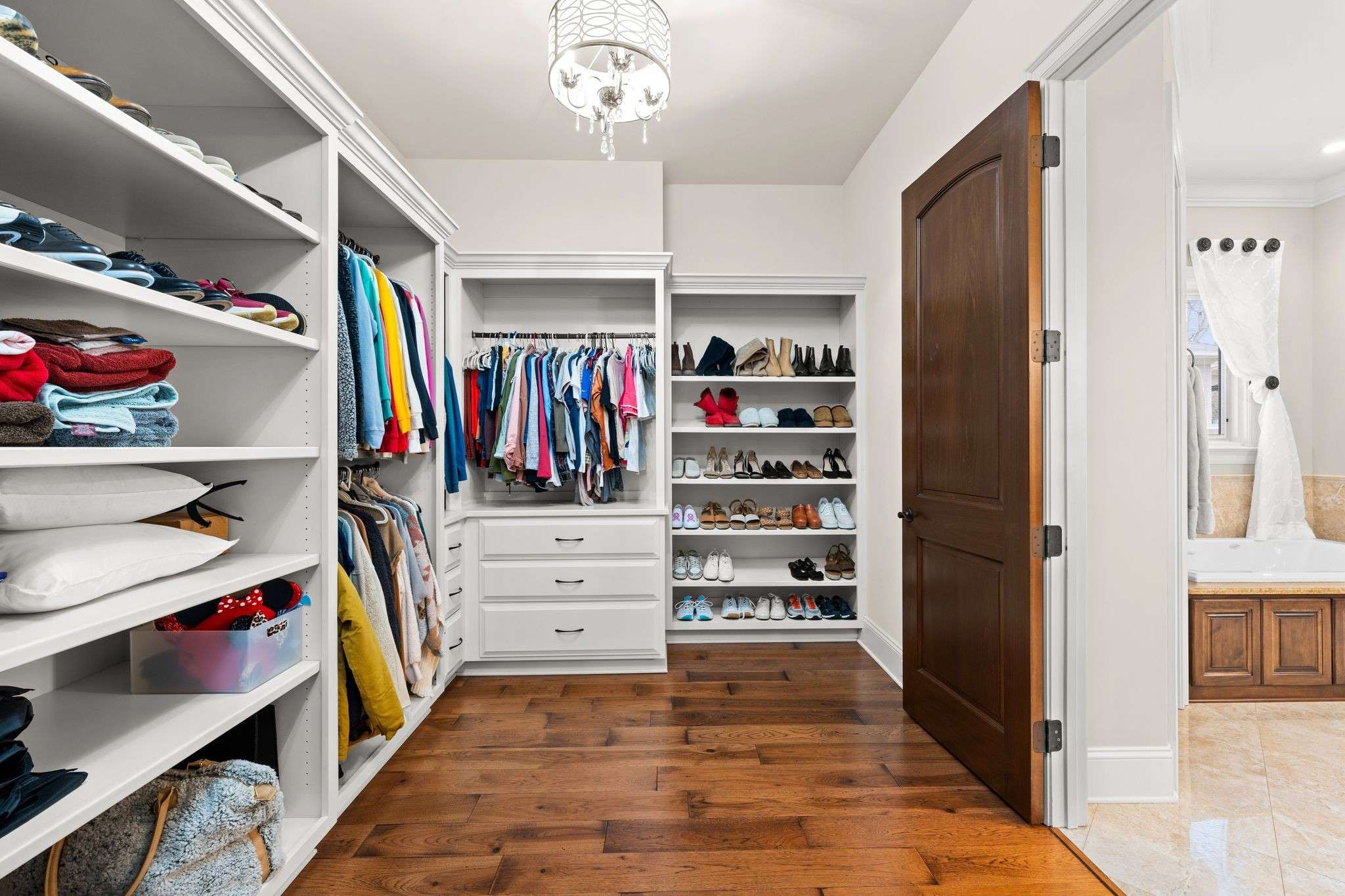 32 of 79. Interior Photo - 846 Armstrong Rd - Photo of Primary Closet off of Ensuite bathroom with custom builtins
