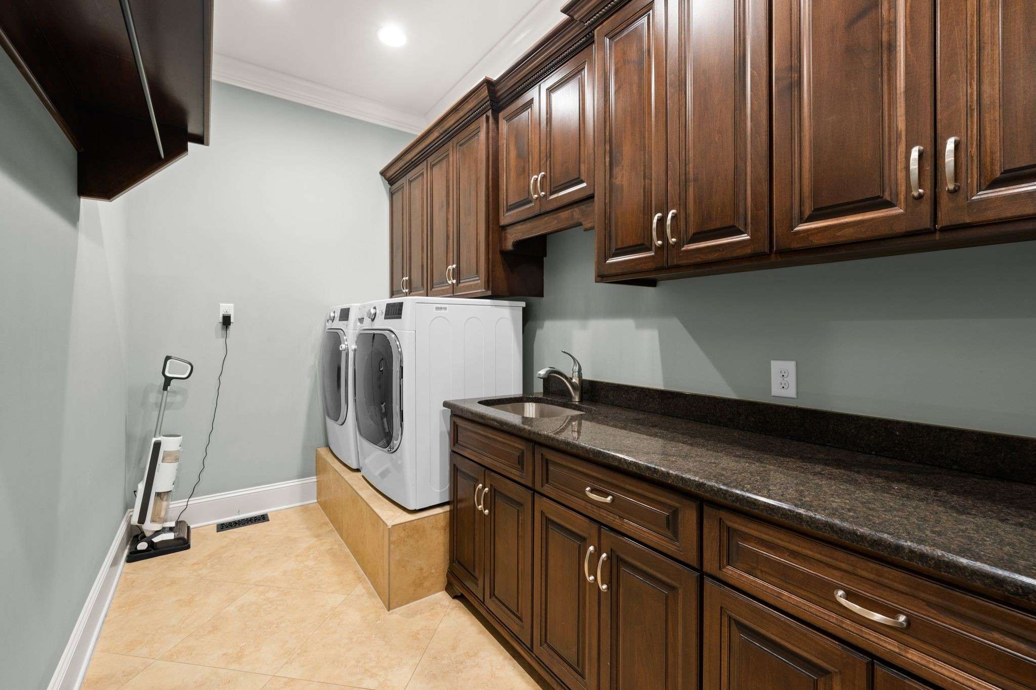 40 of 79. Interior Photo - 846 Armstrong Rd - Photo of Laundry Room, tons of custom cabinets, which also includes sink.