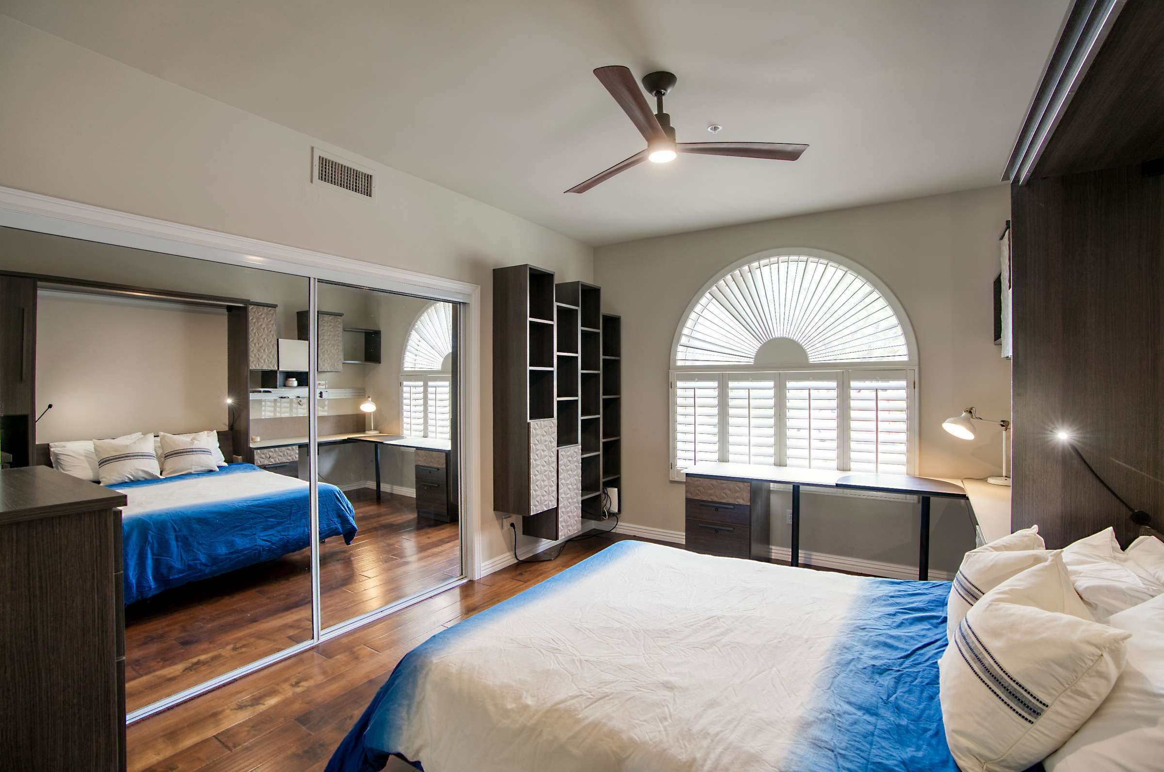 20 of 65. A guest room that works overtime this space includes a sleek Murphy bed, custom shelving, and built-in desk. Perfect for hosting visitors or remote work in a smart, space-saving design.