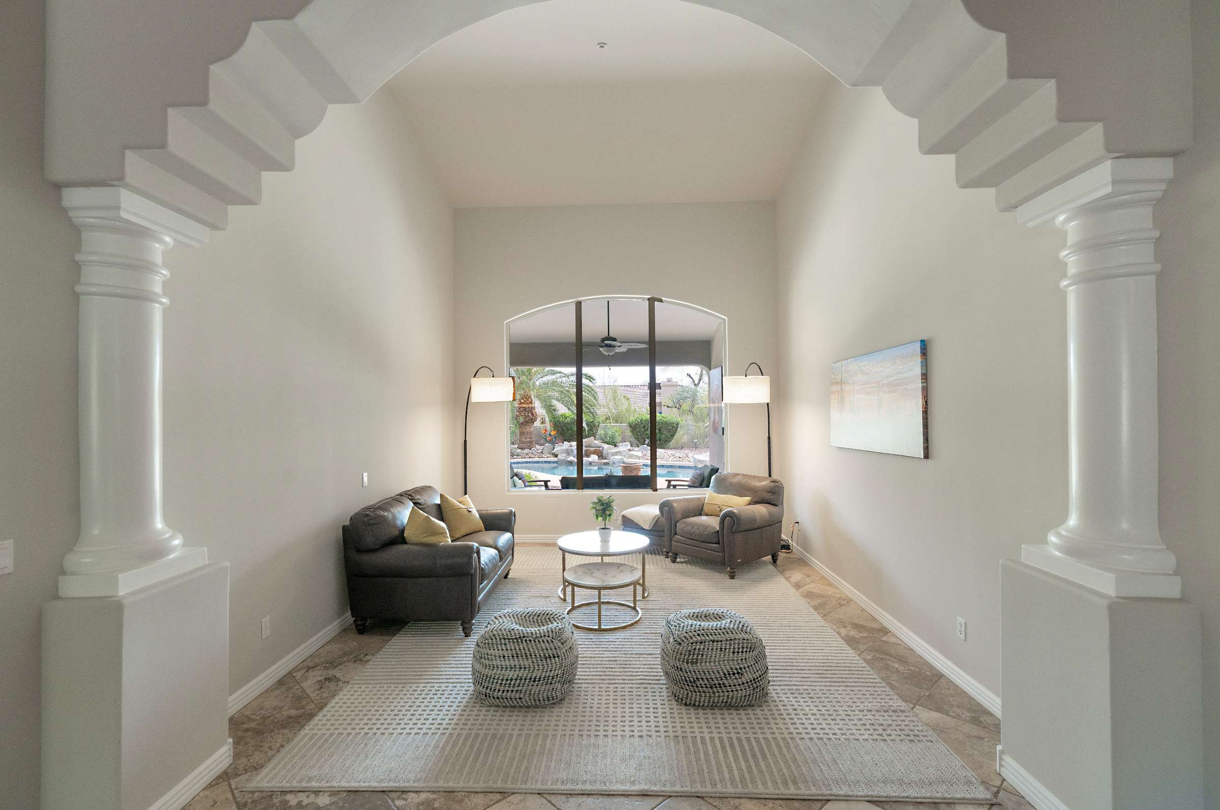 26 of 65. Enjoy the elegance of arched pillars, tile flooring, and picture windows framing the backyard an ideal setting for entertaining or relaxing in refined style.
