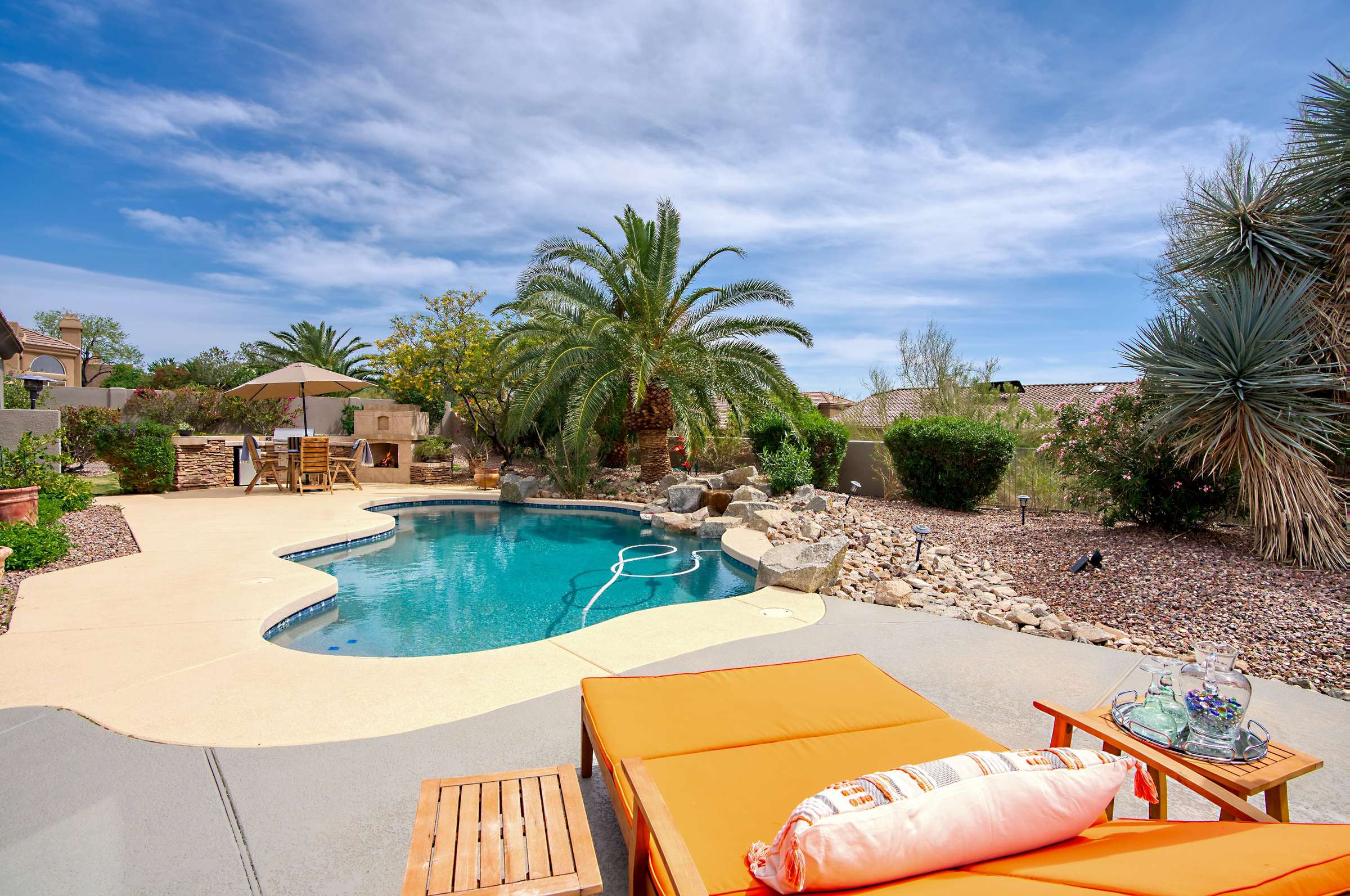 38 of 65. Grill and entertain in style with this beautifully upgraded outdoor kitchen featuring a stone-clad island, new BBQ, and bar seating. Perfect for casual nights or festive gatherings by the pool.