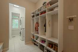 Main Floor Laundry / Utility Room with Custom Cabinetry