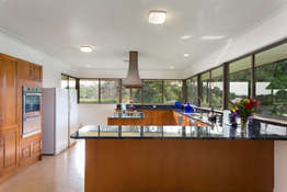 The large kitchen has expansive river and rural views. Solid timber cabinet doors.