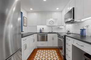 Fabulous renovated Arlington Watermill Place condo with rare private deck & 2 parking spaces