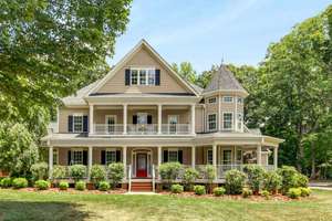 Lovely custom-built Victorian home situated on over an acre with an oversized wrap around covered porch!