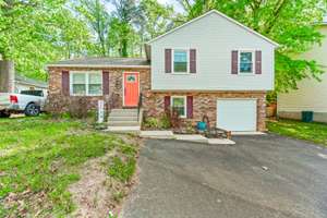 Modern split-level gem with cathedral ceilings, updated kitchen, tranquil bedrooms, versatile lower level, and scenic views from deck.