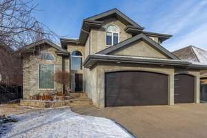 A custom-built home backing onto a pond in Terwillegar