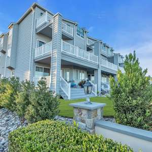 STUNNING OCEAN & RIVER VIEWS WITH PRIVATE BEACH ACCESS! This completely renovated end unit town home features 3BR/3.5BA with unobstructed water views