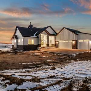 WELCOME HOME TO THIS STUNNING MODERN FARMHOUSE Bring the outdoors in with a home bathed in natural light from a wall of windows and 360 degree vistas