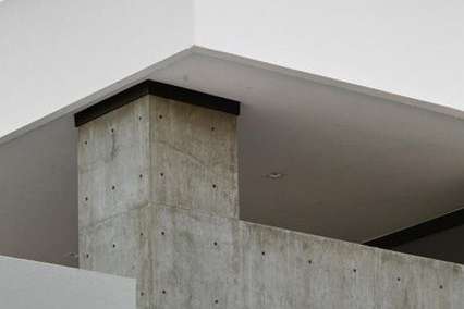 25 of 27. This detailed architectural shot captures the geometric precision of the roofline highlighting the crisp design and expertly executed concrete and stucco finish.