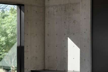14 of 27. This close-up captures the minimalist sophistication of the living room s black steel fireplace and concrete feature wall ideal for energy-efficient warmth and modern appeal.
