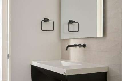 23 of 27. This minimalist powder room showcases a floating vanity, wall-mounted fixtures, and clean design all framed in a soft neutral palette ideal for contemporary Phoenix living.