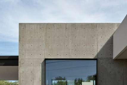 26 of 27. A bold corner window framed by raw concrete creates a striking visual contrast. This detail reinforces the home s modern aesthetic and architectural craftsmanship.