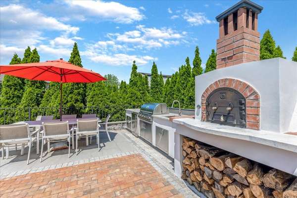 Who doesn't like a woodburning pizza oven, large gas BBQ, and outdoor sink in your outdoor kitchen