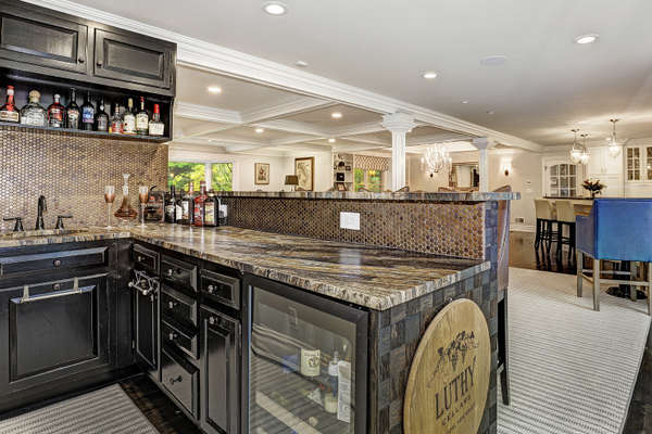 WET BAR BOASTS A BEVERAGE COOLER AND BAR SEATING