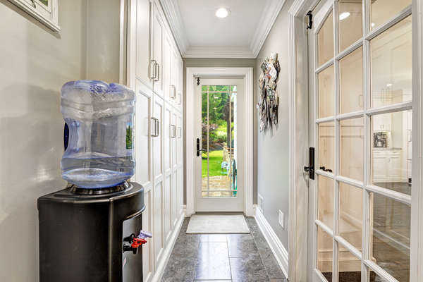 MUD ROOM WITH DOOR TO BACKYARD AND PANTY CLOSETS