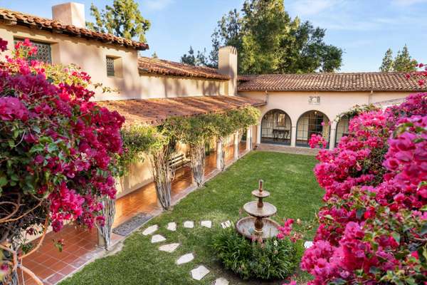 Step beyond the gates into a world of timeless elegance and true hacienda living at the Charles H. Thorne House — a remarkable 1928 estate designed by renowned architect Wallace Neff.