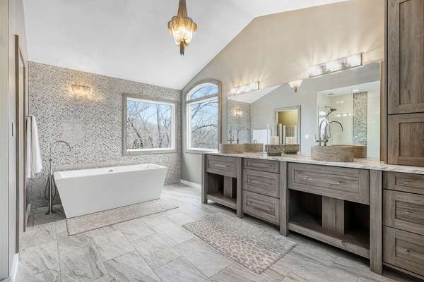 Gorgeous, vaulted, spa-like, luxury bath with custom made double vanity and stand alone designer soaking tub.