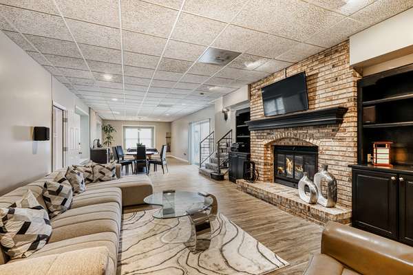 Lower level features a large rec room, with wood burning fireplace and TV area.