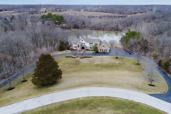 Overlooking the neighborhood lake, in the desirable Wakefield Farm subdivision.