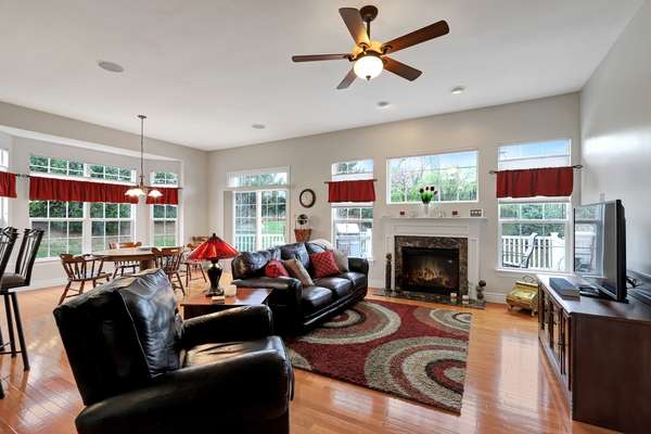 Living Room with a gas fireplace flanked by windows overlooking the private deck and common grounds!